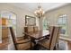 Cozy dining room with hardwood floors, chandelier and large windows for natural light, plus a breakfast bar at 3201 Oaklea Dr, Deland, FL 32720