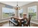 Cozy dining room featuring a wood table, bench seating, and a decorative farmhouse sign above the window at 3201 Oaklea Dr, Deland, FL 32720