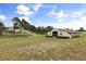 Picturesque view of the home and barn on an estate featuring a well-maintained landscape and serene setting at 3201 Oaklea Dr, Deland, FL 32720