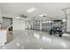 Spacious garage with epoxy flooring, two car doors, and a golf cart at 3201 Oaklea Dr, Deland, FL 32720