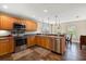 Eat-in kitchen with stainless steel appliances, wooden cabinetry and recessed lighting, perfect for cooking at 3201 Oaklea Dr, Deland, FL 32720