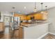 Bright kitchen featuring stainless steel appliances, custom wooden cabinets, and a breakfast bar at 3201 Oaklea Dr, Deland, FL 32720