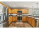 Well-lit kitchen featuring stainless steel appliances, wooden cabinets, and tile floors at 3201 Oaklea Dr, Deland, FL 32720