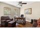 The office has hardwood floors, a ceiling fan, and windows for natural light and backyard view at 3201 Oaklea Dr, Deland, FL 32720
