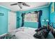 This comfortable bedroom features a window with blinds and curtains, and a door that offers easy access at 3312 Se 6Th St, Ocala, FL 34471