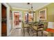 Cozy dining area adjacent to the kitchen, featuring a chandelier and seating for four at 3312 Se 6Th St, Ocala, FL 34471