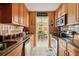 Galley kitchen with granite countertops, tile backsplash, and stainless steel appliances at 3312 Se 6Th St, Ocala, FL 34471