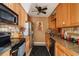Modern kitchen with updated appliances, granite countertops, and wooden cabinetry at 3312 Se 6Th St, Ocala, FL 34471