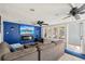 Inviting living room boasts a large sectional sofa, TV, modern ceiling fan, and bright, natural light at 3312 Se 6Th St, Ocala, FL 34471