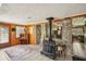 Unique and inviting living room with stone wall accents and a modern wood-burning stove at 3312 Se 6Th St, Ocala, FL 34471