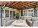 Enjoy outdoor gatherings on this cozy, covered patio with comfortable seating and charming decor at 3312 Se 6Th St, Ocala, FL 34471