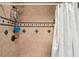 Tiled shower features dual showerheads, a built-in caddy, and decorative accents for a spa-like experience at 3312 Se 6Th St, Ocala, FL 34471