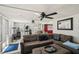 Relaxing sun room featuring a comfortable sectional, ceiling fans, and a peek into an adjacent game room at 3312 Se 6Th St, Ocala, FL 34471