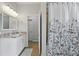 Bathroom with a bright white vanity, a floral shower curtain and plenty of space at 405 Courtlea Park Dr, Winter Garden, FL 34787