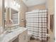 Well-lit bathroom featuring a decorative shower curtain and a white marble vanity at 405 Courtlea Park Dr, Winter Garden, FL 34787