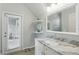 Bright bathroom featuring marble countertop vanity, shelving, and a view of the enclosed porch at 405 Courtlea Park Dr, Winter Garden, FL 34787