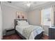 Cozy bedroom featuring a full-sized bed and neutral decor with natural lighting from the window at 405 Courtlea Park Dr, Winter Garden, FL 34787
