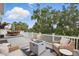 Spacious outdoor deck with firepit, seating, and a dining table, perfect for entertaining at 405 Courtlea Park Dr, Winter Garden, FL 34787
