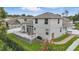 Back exterior of the home featuring a deck, patio, landscaped lawn, and well-maintained yard at 405 Courtlea Park Dr, Winter Garden, FL 34787