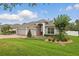 Lovely home with a brick driveway, two-car garage, a well-manicured lawn, and tasteful landscaping at 405 Courtlea Park Dr, Winter Garden, FL 34787