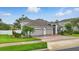 Charming two-story home with a well-manicured lawn, brick driveway, and a spacious two-car garage at 405 Courtlea Park Dr, Winter Garden, FL 34787