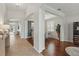 Inviting hallway featuring tiled and wood flooring, architectural columns, and plenty of natural light at 405 Courtlea Park Dr, Winter Garden, FL 34787