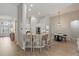 Open kitchen with bar seating, stainless appliances, light cabinets and seamless flow to living spaces at 405 Courtlea Park Dr, Winter Garden, FL 34787