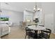 Bright kitchen boasts white cabinets, stainless steel appliances, marble countertops, and an eat-in dining area at 405 Courtlea Park Dr, Winter Garden, FL 34787