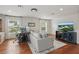 Bright living room features wood floors, modern desk, and flat screen tv for entertainment at 405 Courtlea Park Dr, Winter Garden, FL 34787