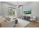 Bright living room with a ceiling fan, TV, plush seating, and access to an outdoor balcony at 405 Courtlea Park Dr, Winter Garden, FL 34787
