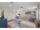 Spacious living room with couch, wood floors, built-in shelving, and a bathroom at 405 Courtlea Park Dr, Winter Garden, FL 34787