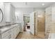Luxurious main bathroom with a glass shower, granite countertops, and and sinks at 405 Courtlea Park Dr, Winter Garden, FL 34787