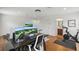 Home office featuring dual monitors, exercise bike, and adjacent bathroom at 405 Courtlea Park Dr, Winter Garden, FL 34787