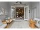 Enclosed porch with white wicker furniture, tile floor and view of interior at 405 Courtlea Park Dr, Winter Garden, FL 34787