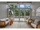 Bright sunroom featuring neutral decor and sliding glass doors that lead to an outdoor deck at 405 Courtlea Park Dr, Winter Garden, FL 34787