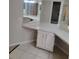 Bathroom vanity with a corner design, a large mirror, and white cabinets at 4371 Aqua Vista Dr # G, Orlando, FL 32839