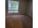 The bedroom is well-lit, with neutral walls, carpeted floor, and a large window at 4371 Aqua Vista Dr # G, Orlando, FL 32839