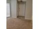 Entryway featuring neutral carpet and tile, leading to the main living area with natural light at 4371 Aqua Vista Dr # G, Orlando, FL 32839