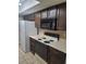 Functional kitchen with dark cabinets, appliances, and ample counter space for meal preparation at 4371 Aqua Vista Dr # G, Orlando, FL 32839