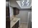 Efficient kitchen with dark cabinetry, neutral countertops, and tiled flooring, providing functional space at 4371 Aqua Vista Dr # G, Orlando, FL 32839