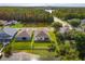Aerial shot of the home's backyard bordering a pond with lush greenery and serene views at 4642 Waterside Pointe Cir, Orlando, FL 32829