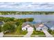 Aerial view of home by a lake with a well-maintained lawn, framed by lush greenery and neighborhood at 4642 Waterside Pointe Cir, Orlando, FL 32829