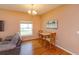 Cozy dining area featuring hardwood floors, a chandelier, and backyard views at 4642 Waterside Pointe Cir, Orlando, FL 32829