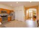 Bright kitchen featuring stainless appliances, tile flooring, and easy access to foyer at 4642 Waterside Pointe Cir, Orlando, FL 32829