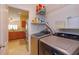 Well-equipped laundry room with modern appliances and a glimpse into a spacious kitchen at 4642 Waterside Pointe Cir, Orlando, FL 32829