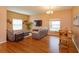 Inviting living room and dining area with neutral walls, wood floors, and backyard views at 4642 Waterside Pointe Cir, Orlando, FL 32829