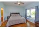 Serene main bedroom with wood floors and views of the backyard at 4642 Waterside Pointe Cir, Orlando, FL 32829