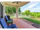 Inviting covered patio with seating, ideal for outdoor relaxation and entertaining with a well-maintained yard view at 4642 Waterside Pointe Cir, Orlando, FL 32829