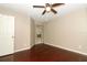 Bedroom featuring gleaming hard wood floors, lighted ceiling fan and window with light filtering curtains at 620 Glenwood Ct # 79, Altamonte Springs, FL 32714