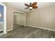 A cozy bedroom featuring hardwood floors, a mirrored closet, and a unique ceiling fan at 620 Glenwood Ct # 79, Altamonte Springs, FL 32714